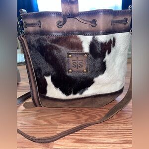 STS Cowhide Bucket Bag. Bottom 11in, Depth 5in, Height 9.5in, Strap Length 42in